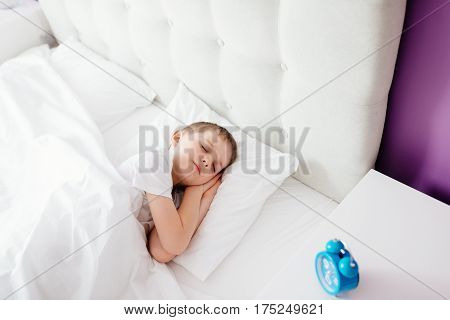 Little Boy Child Sleeping In Bed. Hugging His Favourite Teddy Bear