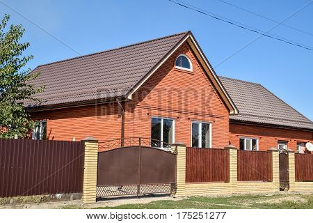 Detached House With A Roof Made Of Steel Sheets.