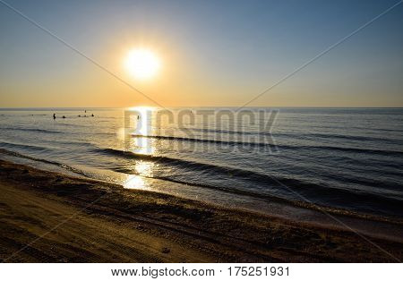 Sea Sunset. People Bathe In The Evening At Sunset In The Sea.