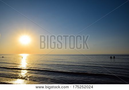 Sea Sunset. People Bathe In The Evening At Sunset In The Sea.