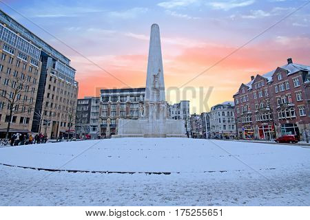 Snowy Damsquare in Amsterdam the Netherlands with the National Monument in winter