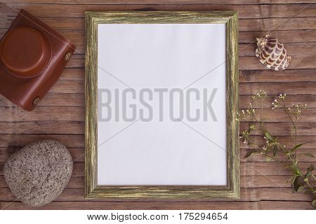 White page in vertical wooden frame photo background. Rustic wooden board backdrop with natural decor. Retro style flat lay with sea pebble and shell. Shabby chic banner template with place for text