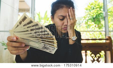 Money In Hand With Statement Paper And Feeling Stressful. In Finnancial Concept