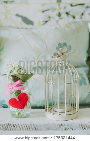 candlestick with bird and snowdrops in spring backgroud