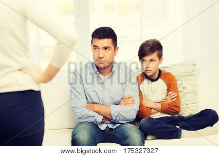 people, misbehavior, family and relations concept - upset feeling guilty or displeased father, son and angry mother at home