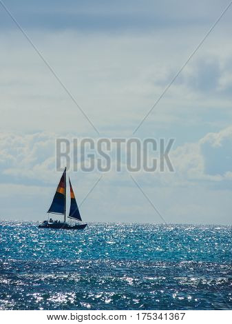rainbow sailboat of the shore at waikiki beach