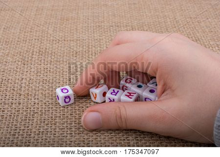 Colorful Alphabet Letter Cubes In Hand