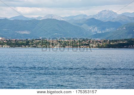 Landscape of the coast of Sirmione peninsula which divides the lower part of Lake Garda. It is a famous vacation place for a long time in northern Italy.