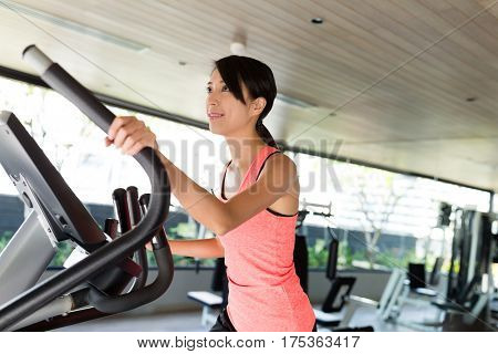 Sport Woman training on Elliptical machine