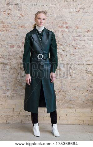 MILAN ITALY - FEBRUARY 25: Gorgeous model wears her own cloths and poses in the backstage just before Cividini show during Milan Women's Fashion Week on FEBRUARY 25 2017 in Milan.