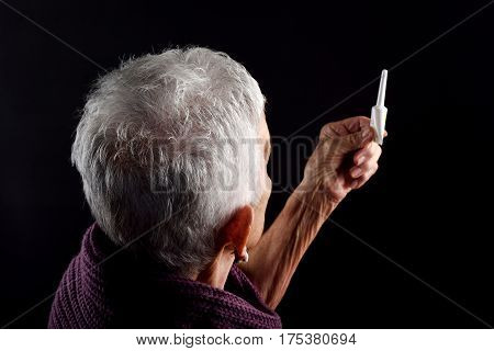 Senior woman Laxative on a black background