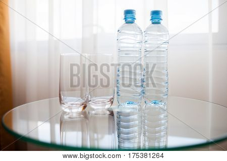 Two Bottles And Two Glasses On The Table.