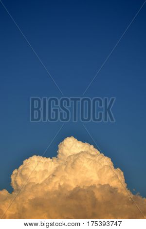 White fluffy cloud against a blue clear sky