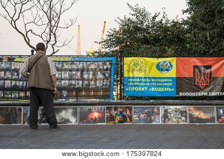 ODESSA UKRAINE - AUGUST 14 2015: Man paying respect to the people killed during the Maidan - Euromaidan revolts of 2014 at a memorial erected in Odessa