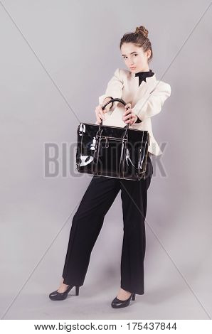 Front View Of A Young Smiling Business Woman With Ladies Bag.
