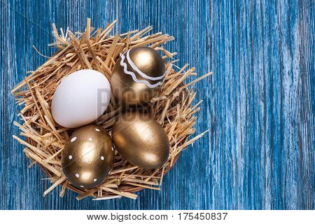 omposition with colorful Easter eggs on blue wooden table