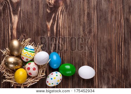 Colorful easter edds on a brown wooden table