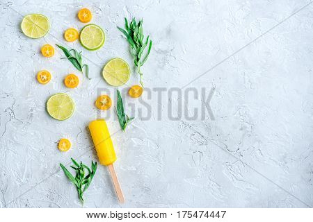 homemade citrus popsicles with fresh fruit slices on stone table background top view mockup