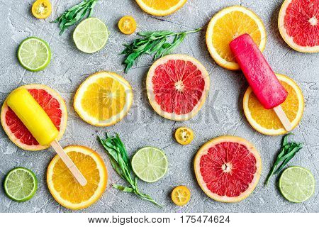 Homemade orange ice cream with fresh fruits on stone table background top view pattern