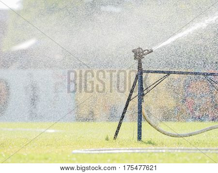 Sprinkler watering the grass of the football field