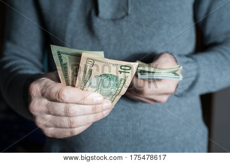 Man Giving Us Dollar Banknote And Holding Cash In Hands.