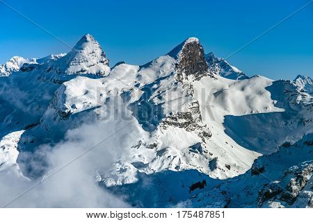 Beautiful Mountains In Snow. Evening Aerial View With Shadows.
