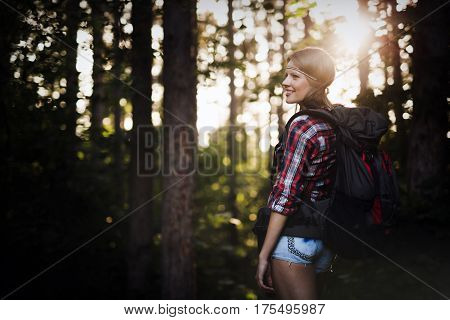 Female backpacker set out on forest hike advanture