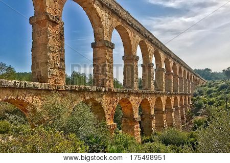 Tarragona, Spain, February 22, 2017: The Roman aqueduct at Tarragona in Spain.