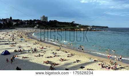 Sydney Australia - Feb 5 2017. People relaxing swimming and sun bathing on Coogee beach. Located on Sydney's famous Coastal Walkway which stretches from Bondi Beach to Maroubra Beach.