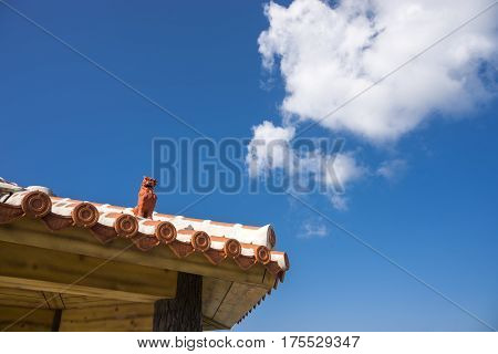Tiled roof arbour on Shisa(Okinawan lion statues) under sky in Ishigaki island