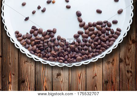 Coffee Beans On A White Plastic Plate. On Beautifull Wooden Background. Love. Insparation. On White