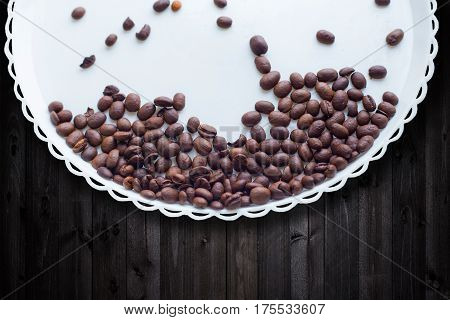 Coffee Beans On A White Plastic Plate. On Beautifull Wooden Background. Love. Insparation. On White