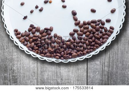 Coffee Beans On A White Plastic Plate. On Beautifull Wooden Background. Love. Insparation. On White