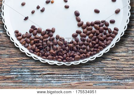 Coffee Beans On A White Plastic Plate. On Beautifull Wooden Background. Love. Insparation. On White