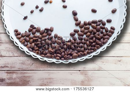 Coffee Beans On A White Plastic Plate. On Beautifull Wooden Background. Love. Insparation. On White