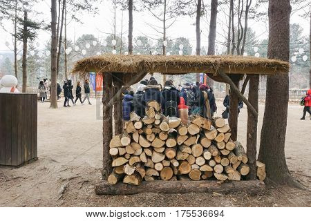 wood logs in shelter ready for flaming to keep people warm in winter taken at Nami island in Seoul Korea on 14 February 2017