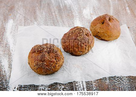 variety of small breads with seeds on grille