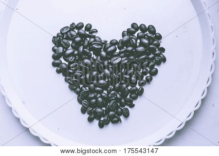 Coffee Beans In Form Of Heart On Beautifull Background. Love. Insparation. On White Plate.