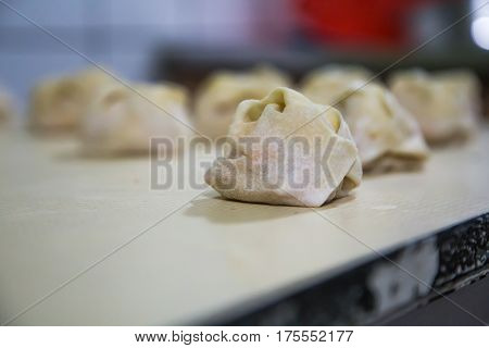 Preparation Of Manti On A Kitchen Wooden Board. Traditional Asian Dumplings