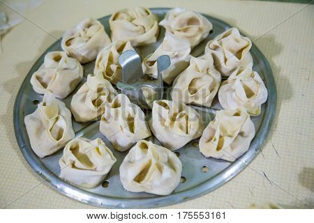 Preparation Of Manti On A Kitchen Wooden Board. Traditional Asian Dumplings