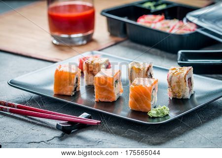 Sushi roll : Set of salmon eel sushi rolls on plate with chopsticks