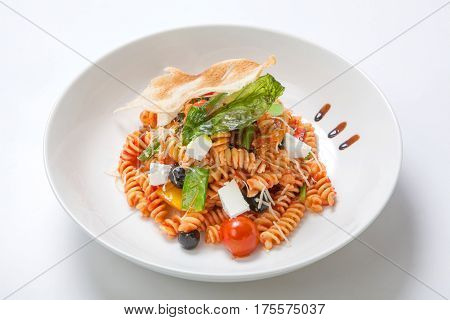 Pasta In Tomato Sauce With Fried Vegetables And Fresh Cherry Tomatoes And Feta