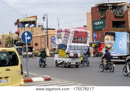 Marrakesh Morocco - March 04 2017: Auto driver unidentified by the narrow streets of the Medina of Marrakech. Chaotic transport through streets