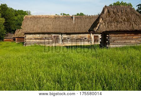Old wooden sheds with moss-grown straw-thatched roofs from the Museum of Folk Architecture and Life of Ukraine in Pyrohiv near Kyiv.