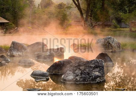 Sun reflecing on the Hot spring at national park during sunrise Thailand