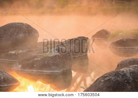 Sun reflecing on the Hot spring at national park during sunrise Thailand