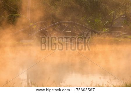 Sun reflecing on the Hot spring at national park during sunrise Thailand