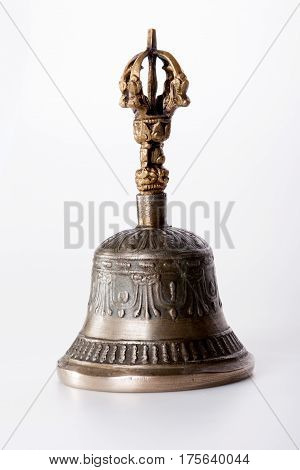 Tibetian bronze buddhist hand bell isolated over a white background