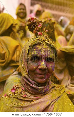 Vrindavan, India - March 21, 2016: An Indian widow celebrating Holi, the Hindu spring festival of colours, at Gopinath Temple in Vrindavan, Uttar Pradesh, India.