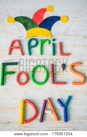 April Fools' Day text made with plasticine on white wooden background